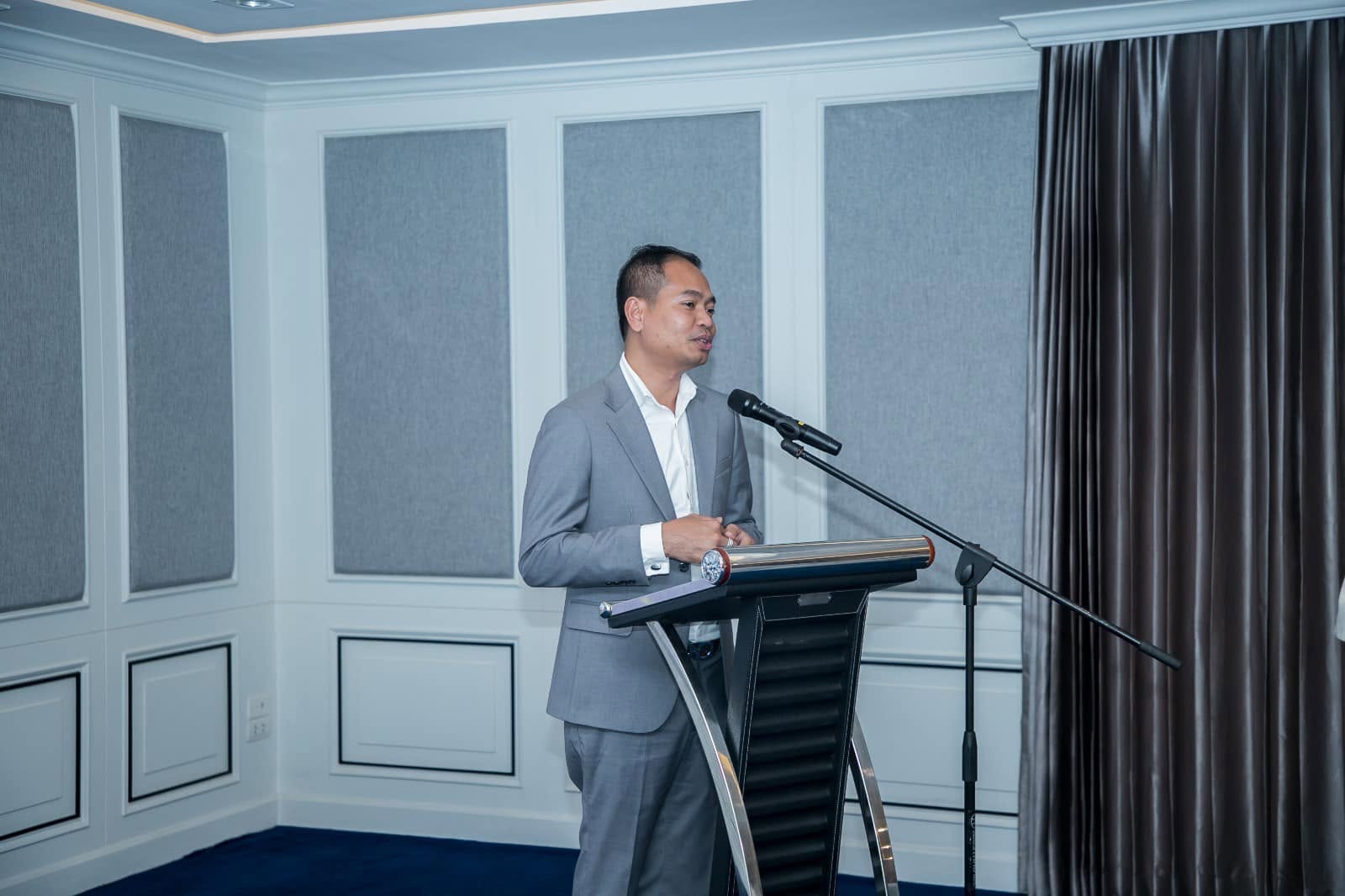 Managing Director Veasna Van speaking at a lectern
